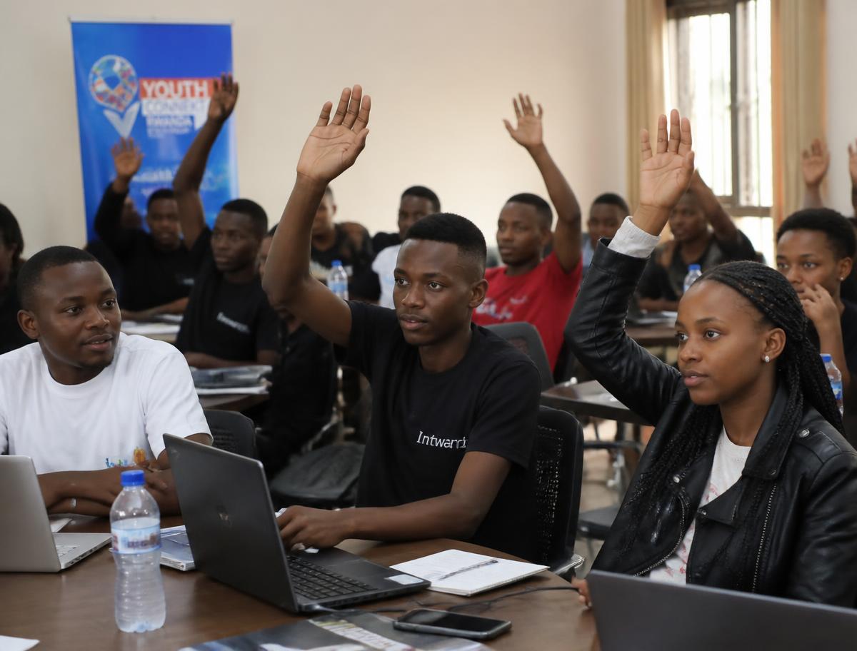Young Rwandans raising their hands during a StackForgeNext training workshop
